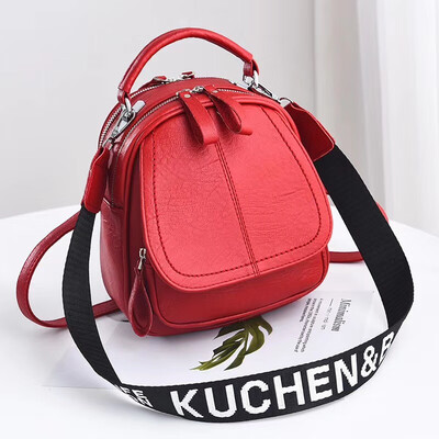

A girl with a double shoulder bag a broadband shoulder bag a Korean version of a backpack a girl slanted a small round bag and