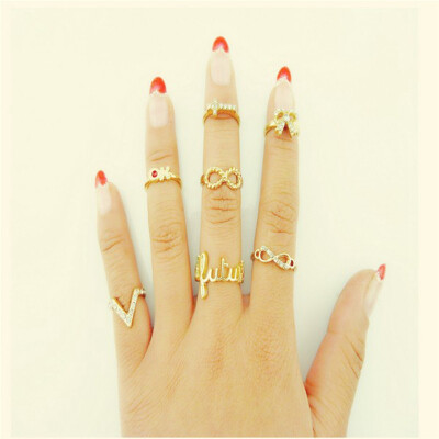 

7Pcs Vogue Gold Crystal Cross Bowknot Design Nail Band Mid Finger Rings Set